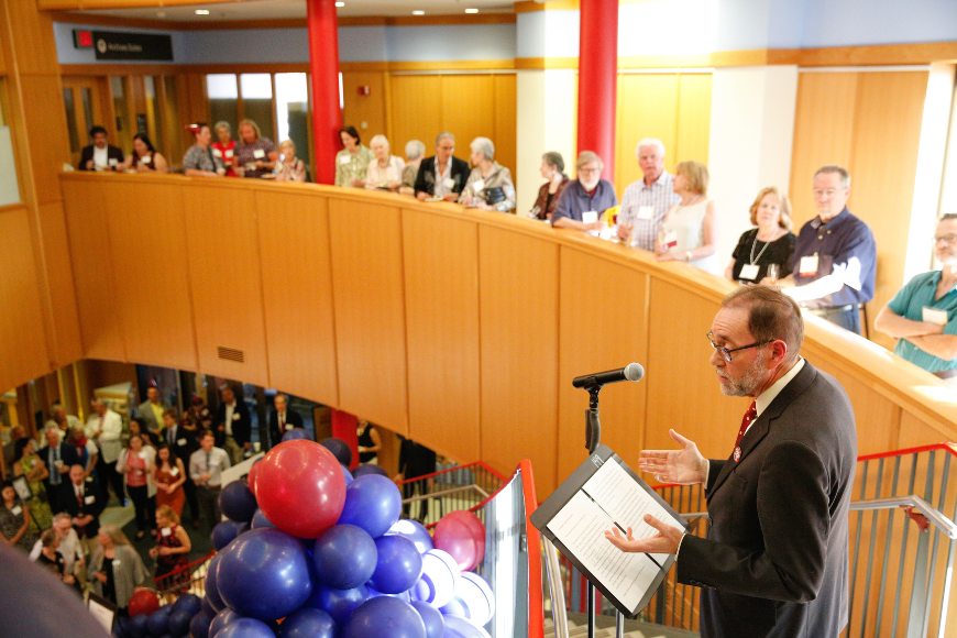 Dean Coleman addresses a crowd of friends during the college's 150th anniversary celebration