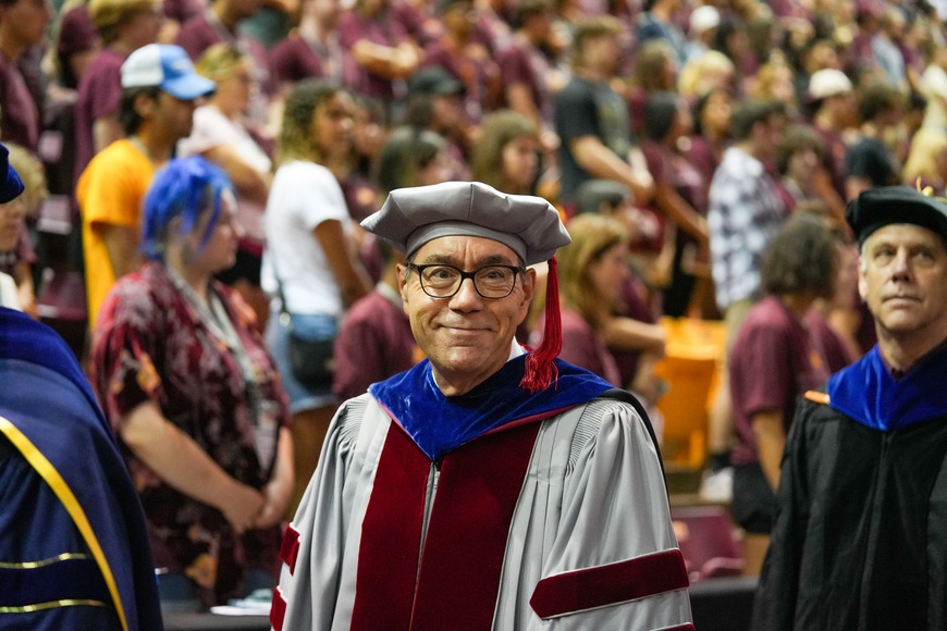 Dean Coleman wearing academic regalia and smiling during College Day 2022