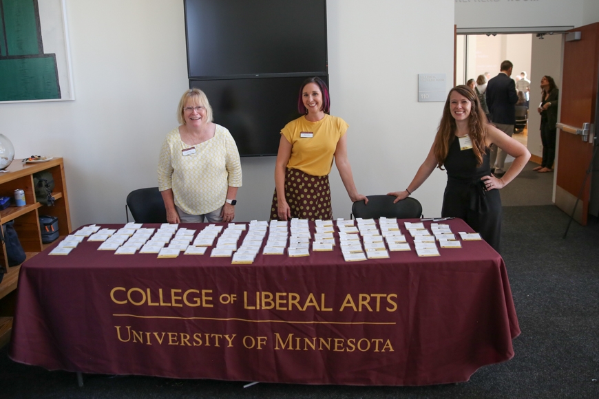 Three staff members greet guests in the entryway of the Weisman Art Museum.