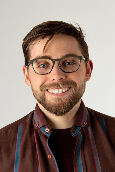 Headshot of Justin Allen smiling against white background