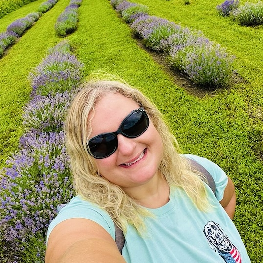 Linguistics professor Amanda Dalola in a field of lavender