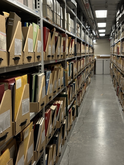 A collection of cabinets holding binders and books.