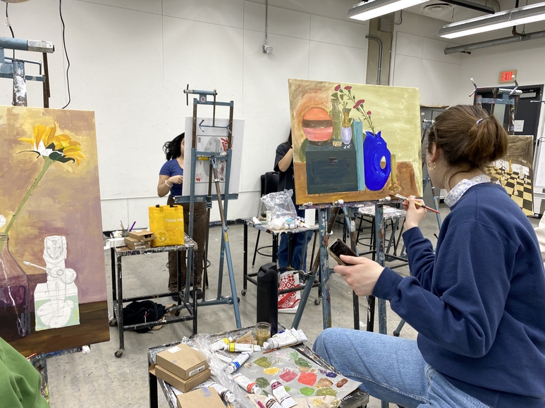 Students painting on easels
