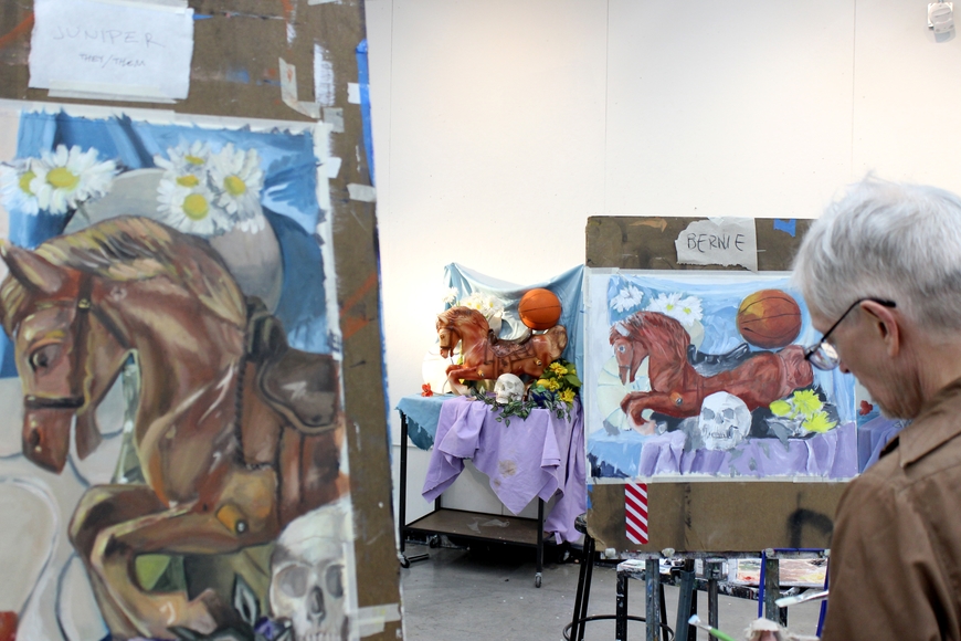 Students painting a still life on easels