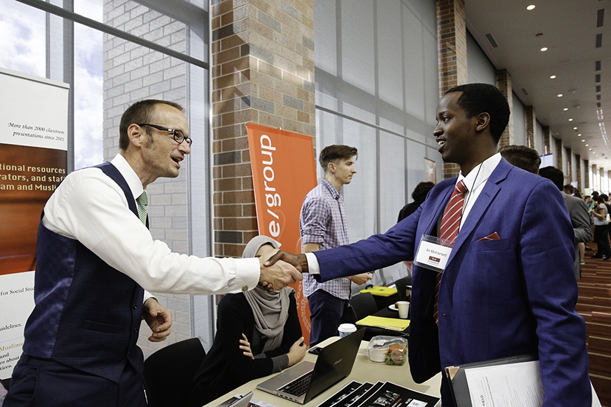 Employer and student shaking hands at Internship Fair