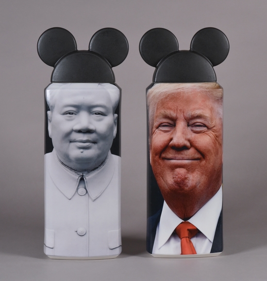 Two vases with black Mickey Mouse hats for lids. The left vase features a black and white photo of Mao Zedong looking at the viewer, the right a color photo of Donald Trump smiling.