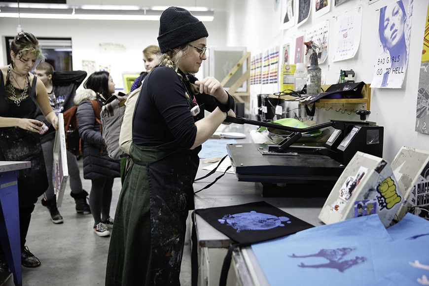 Bohemian Press student group helps guests screenprint custom tote bags during the Arts Quarter Festival.