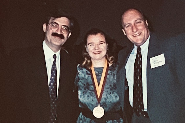  Dean Steven Rosenstone, Lydia (wearing the Dean’s Medal), and former Director of SOM Jeffrey Kimpton (2000)