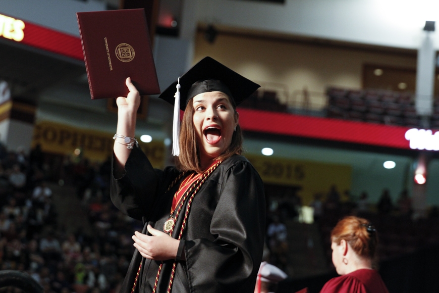 Spring 2015 CLA Commencement - graduate celebrates with diploma cover