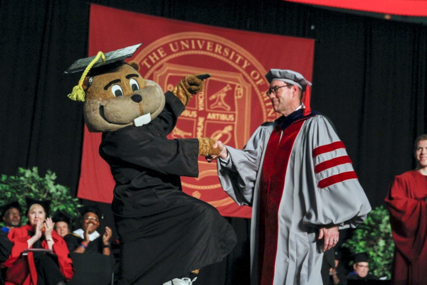 Spring 2015 CLA Commencement - Goldy shakes hands on stage with Dean John Coleman