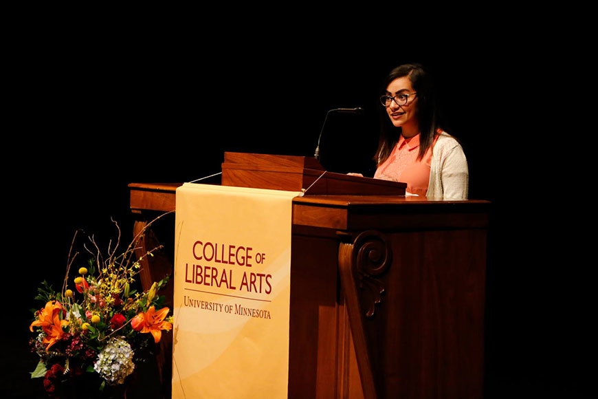 Photo of student Mariam Salama speaking at the podium
