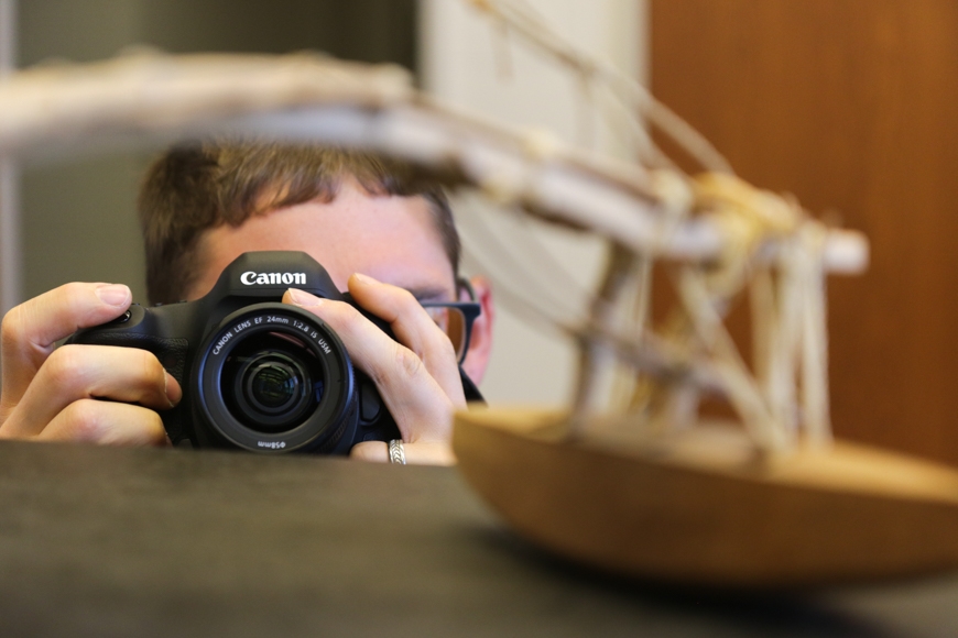 Colin McFadden takes pictures of a traditional outrigger canoe.