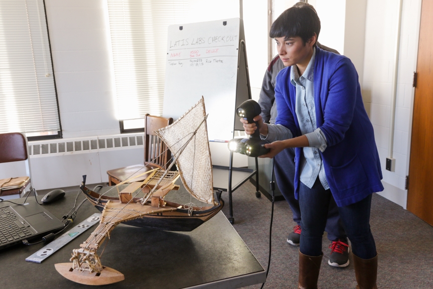 CLA students use a structured light pattern to 3D scan a traditional outrigger canoe.
