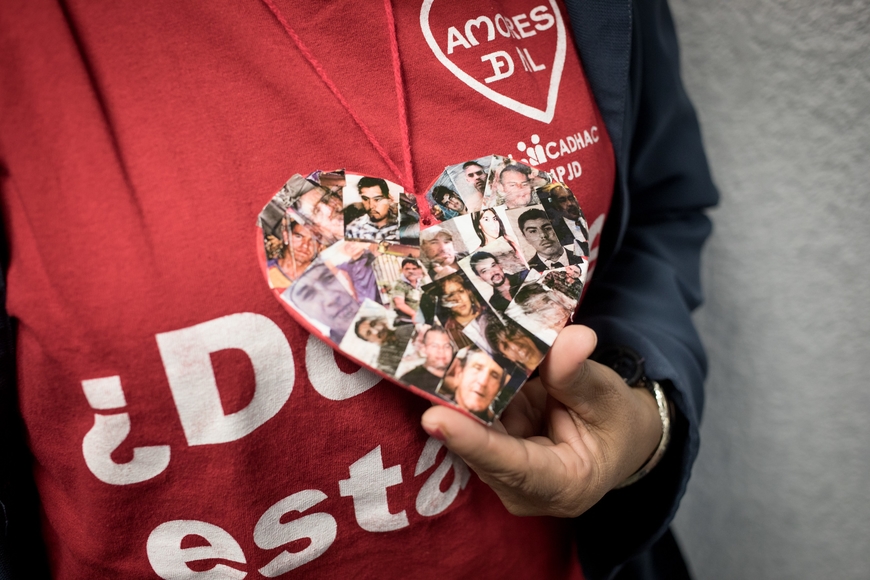 woman in red shirt holding heart with images of a face