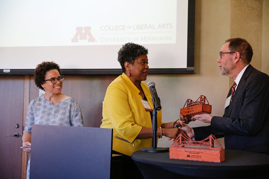 Photo of Robin P. Hickman receiving the Civitas Community Catalyst Award from Dean Coleman while Prof. Catherine Squires looks on.