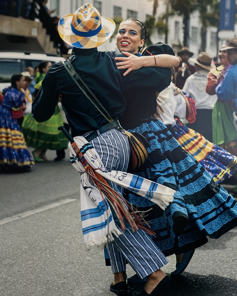 Two people dance in the street