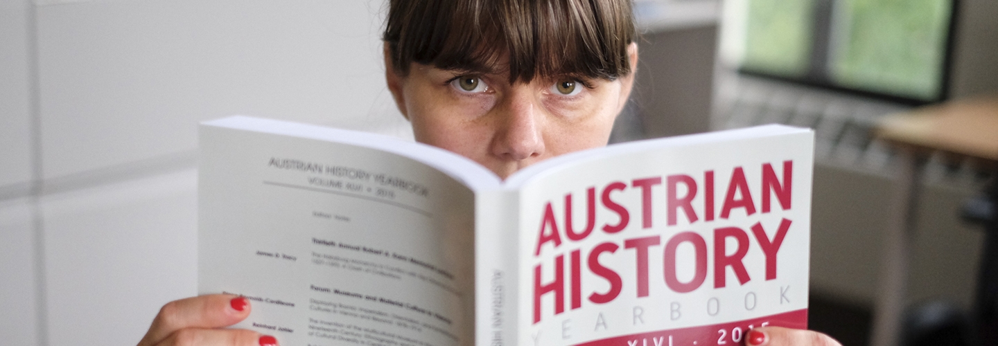 Woman holding Austrian History publication