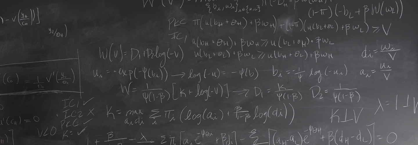 Economics formulas in chalk on blackboard