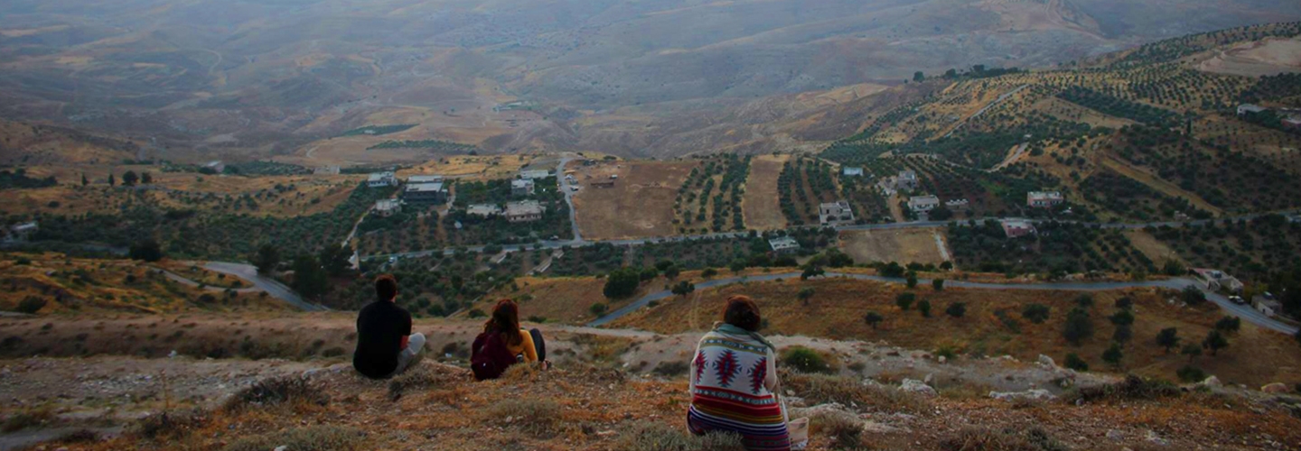 Students on hill overlooking valley