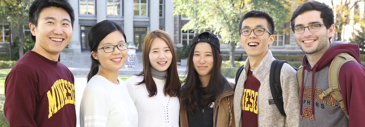 A group of undergrad students posing together on campus
