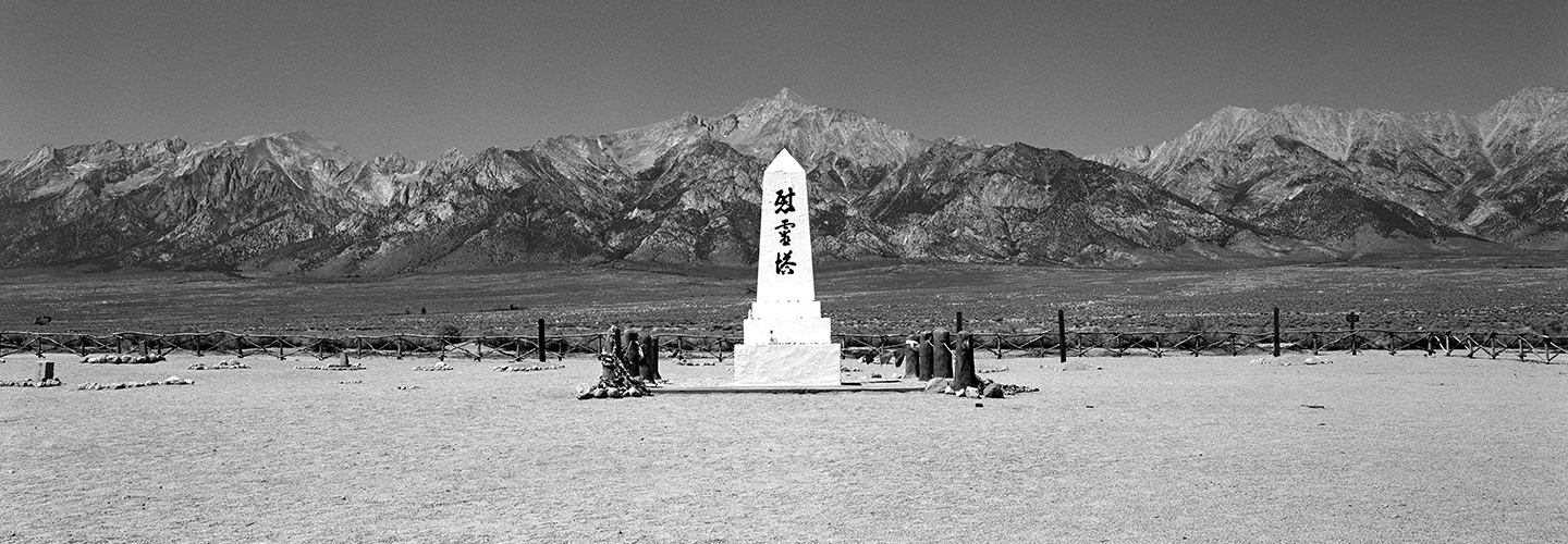 Monument to incarcerated Japanese Americans during World War II at the site of Manzanar with mountains in the background.