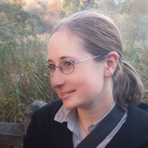 Emily Willoughby, a person with long light brown fair, light skin, wearing glasses