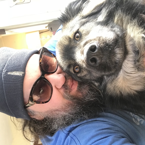 Picture of Mike Baxter-Kauf with his beautiful dog, Teddy.