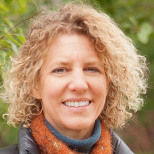 Smiling woman with curly blond hair