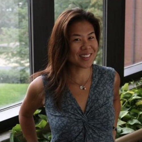 Asian American woman with dark brown hair smiling