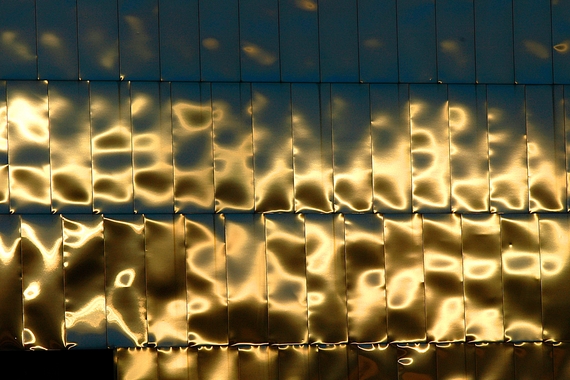 Close up of sun shining against metal siding on the Weisman art musuem