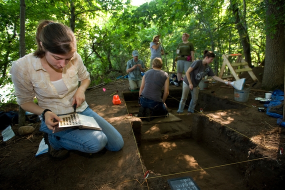 A student performs an archeological dig
