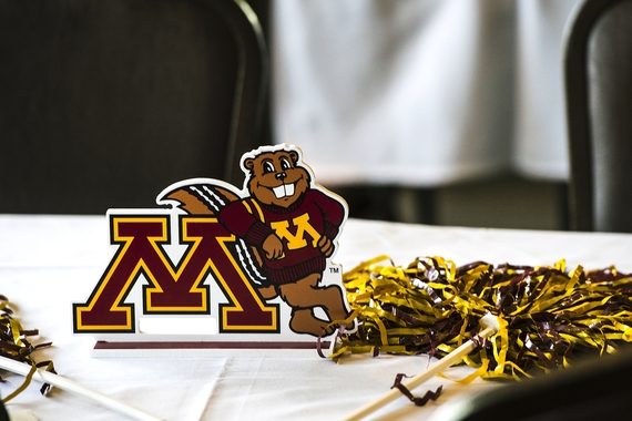 Maroon and gold pom-pom and table tent of Goldy Gopher