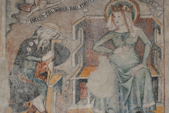 Fourteenth-century fresco depicting Joseph's first dream. A pregnant Mary sits on a bench with a crown on her head while Joseph sits at her side in reverence. 