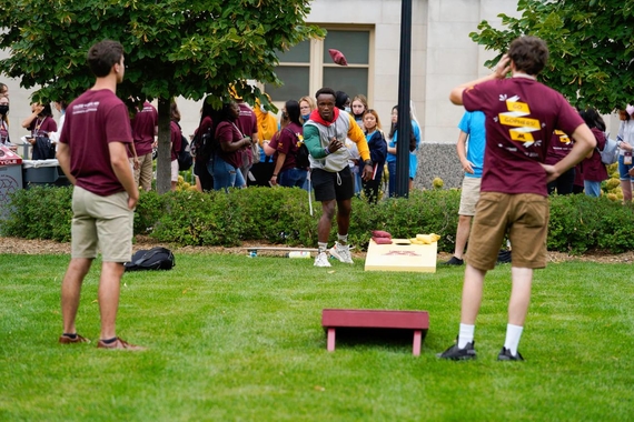 CLA students playing a beanbag toss game during College Day