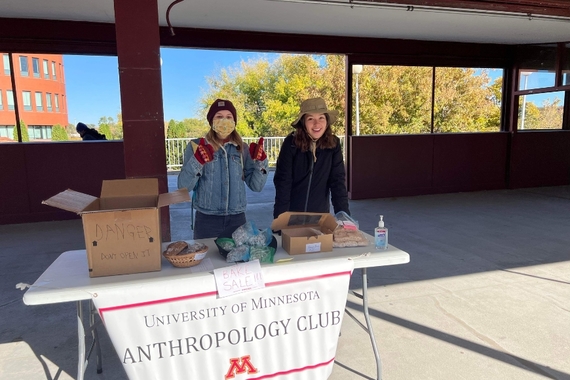Students standing outside in front of an Anthropology Club table