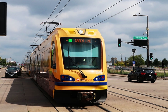 A metro Green Line light rail vehicle passing Snelling Ave
