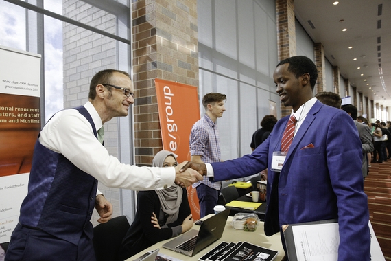 Employer shaking hands with a student at a career fair