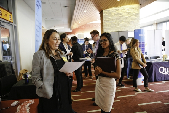 Employer looking over student's resume at a career fair