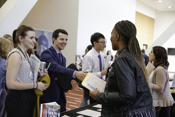 Employer and Student shaking hands at a Career fair