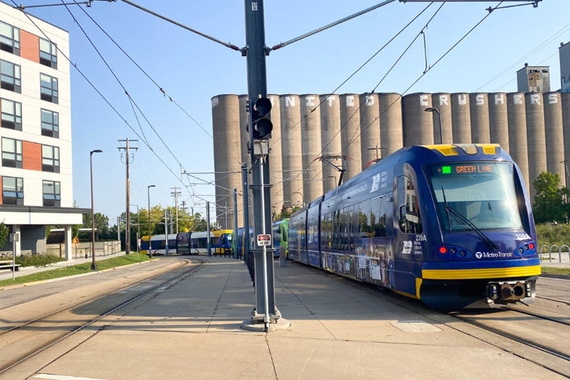 Metro Green Line light rail with United Crushers grain silo in the background
