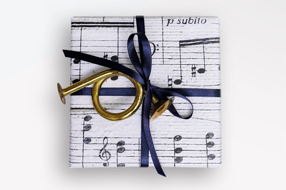 Wrapped package in music note paper with a horn