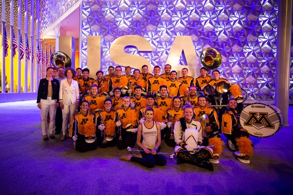 University of Minnesota Marching Band posing in front of the USA sign at the World Expo in Dubai