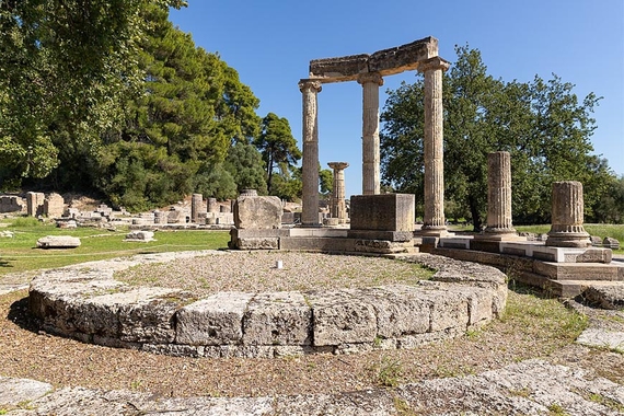 Olympic Flame plaza in Olympia, ancient Greek columns near a stone circle platform