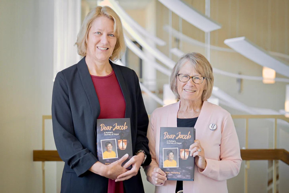 Joy Baker and Patty Wetterling hold a copy of their book Dear Jacob