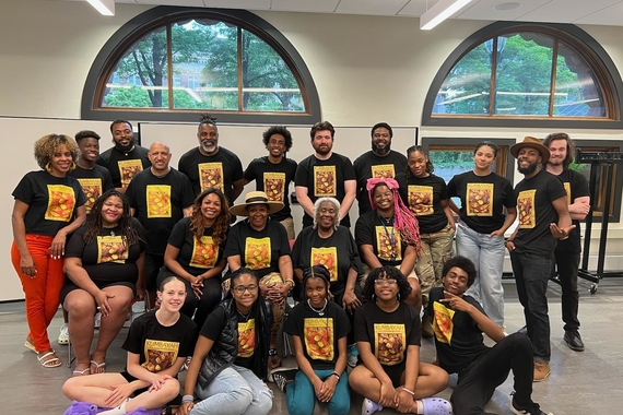 The multigenerational cast of Kumbayah The Juneteenth Story poses in the Hub wearing Kumbayah branded t-shirts.