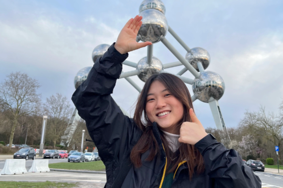 Kaia Brands standing in front of a metal statue, giving a thumbs up.