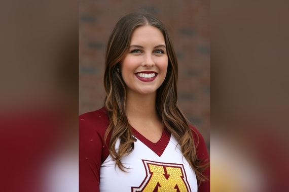 Headshot of Katya Cuthbert wearing a cheer uniform with a large UMN logo on the front