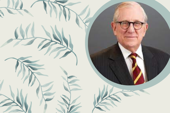 Graphic of blue-green plant fronds on cream background, with circle photo of person with short grey hair, light skin, wearing dark rimmed glasses and dark suit with maroon/gold tie.