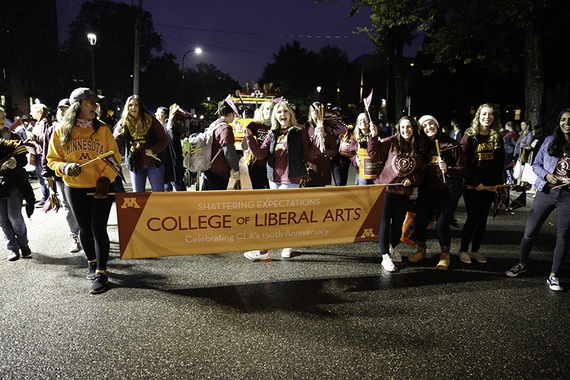 CLA group with banner marching in homecoming parade