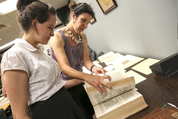 CPS faculty Michelle Hamilton and staff member Lydia Brosnahan consult a text from the UMN Library’s Special Collections.